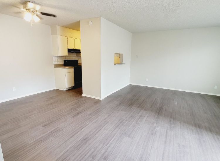 Abode Apartments - 805sqft, 1 Bed 2 Bath - Living Room and Kitchen