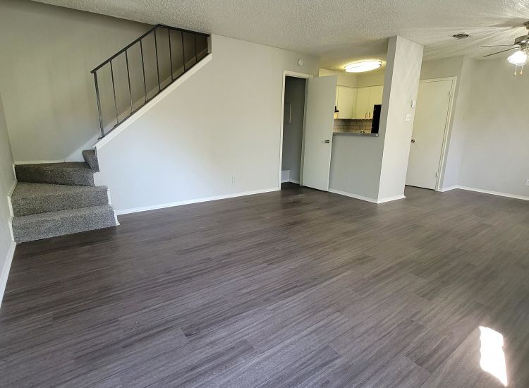 Abode Apartments - 888sqft, 2 Bed 1 Bath - Living Room, Staircase, and Kitchen